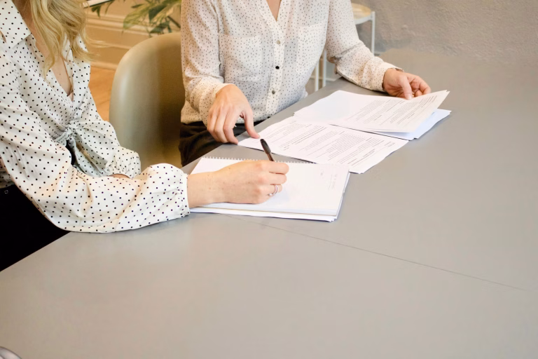 Two people reviewing a printed document